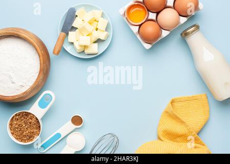 Baking ingredients and utensils on a blue background. Pastry, cake or bread baking recipe mockup Stock Photo