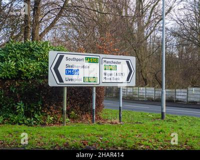 09.10.2021 St Helens, Merseyside, UK. Road sign in Moss Bank showing Liverpool and Manchester on the A580. Editorial Stock Photo