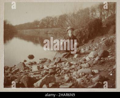 Vintage photograph of a Teenage boy sitting by a river, countryside, North Yorkshire, Edwardian England 1905 Stock Photo