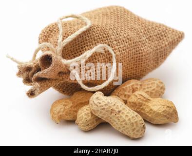 Fresh Peanuts in sack over white background Stock Photo