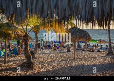 BAYAHIBE, DOMINICAN REPUBLIC - Feb 02, 2020: DOMINICUS, DOMINICAN REPUBLIC 6 FEBRAURY 2020: People on Dominicus Beach at sunset Stock Photo