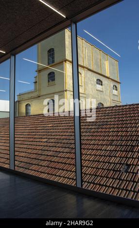 Milan, Italy: The Haunted House designed by Rem Koolhaas, covered with a layer of gold leaf, seen from inside one of the buildings of Fondazione Prada Stock Photo