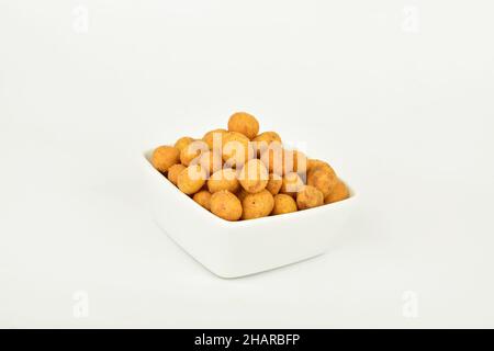 Coated Peanuts in Bowl on White Background Stock Photo