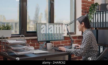 Close up of person looking at stock market statistics on computer, analyzing crypto currency exchange. Entrepreneur using global trade analysis to invest money for company growth. Stock Photo