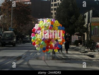 Kabul, Afghanistan. 14th Dec, 2021. Colorful balloons are seen in a street in Kabul, Afghanistan, on Dec. 14, 2021. Credit: Saifurahman Safi/Xinhua/Alamy Live News Stock Photo