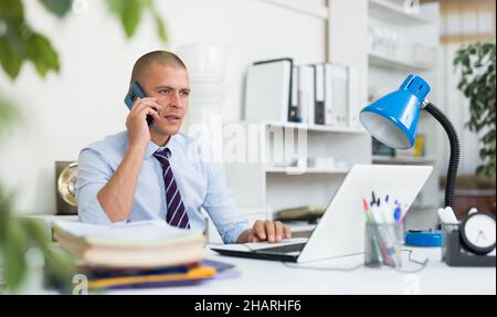 Confident adult man working at office Stock Photo