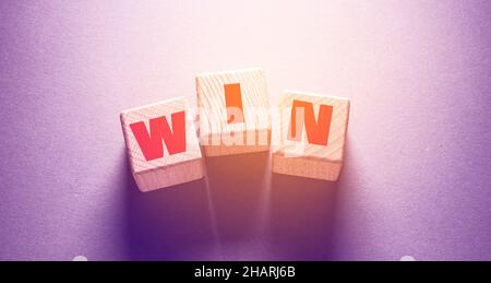 Win Word Written on Wooden Cubes Stock Photo