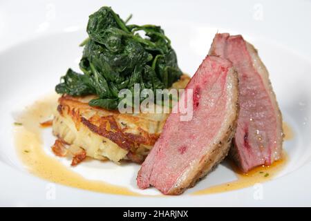 Lamb loin with spinach and potato rosti Stock Photo