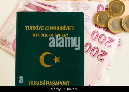 Turkish,green color officer passport and Turkish money  banknotes on the white background.Above view Stock Photo