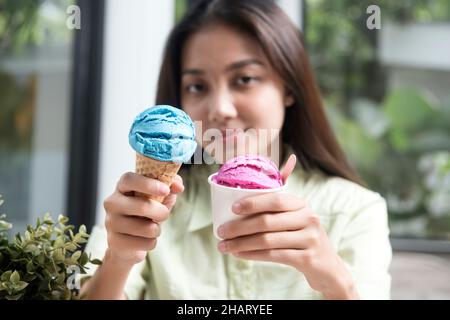 Asian woman holding ice creams in the coffee shop Stock Photo