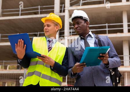 Builder and architect discussing construction Stock Photo
