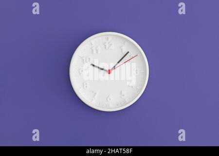 White wall Clock on gree background. Stock Photo
