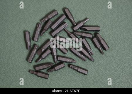 Set of screwdriver bits on a green background Stock Photo