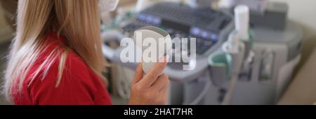 In hand of doctor holding ultrasound probe preparing for examination Stock Photo