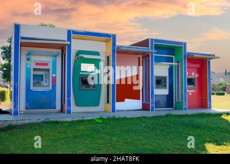 Front view of an ATM on the street. Cash Machines. colorfull. Selective Focus. Sunset sky. Stock Photo