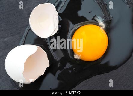 Broken cracked raw egg with eggshell, top view Stock Photo