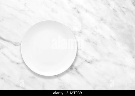 White plate on marble stone table, plate mockup, top view Stock Photo