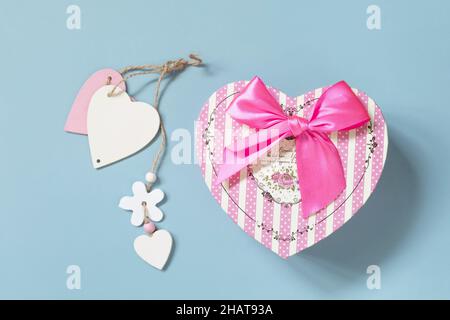 Valentine's day concept with heart gift box on a blue background, minimal layout. Top view flat lay. Stock Photo