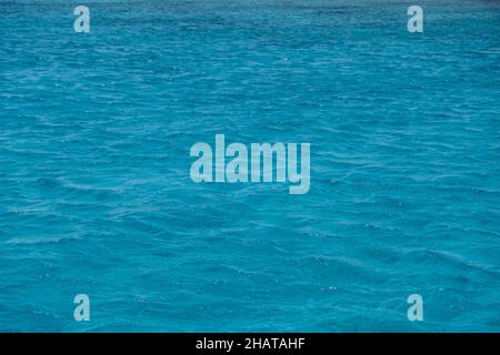 Sea water background, small ripples texture. Ocean surface blue color, clean environment abstract backdrop, summer vacation empty template Stock Photo