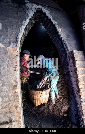 Coal furnace workers prepare to deliver goods to the market Stock Photo