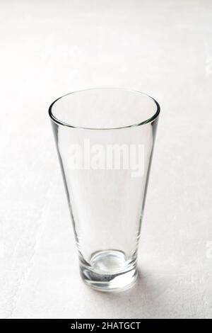 Tall empty glass on a light background, close up of a bar glass Stock Photo