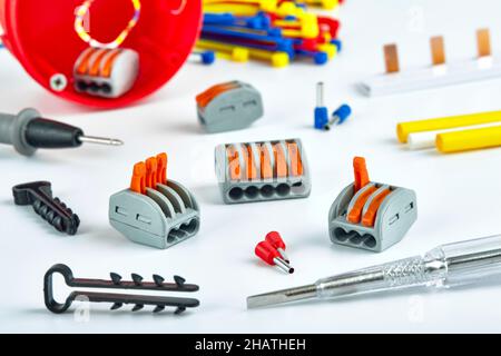 Electrical accessories, screwdriver, clamps, ties on a white background Stock Photo