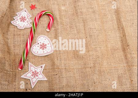 Christmas background with wooden figurines with glare and light spots, artificial snow Stock Photo