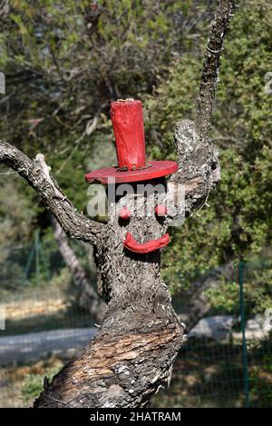 Funny Dead Tree Trunk Sculpture or Tree Scarecrow Stock Photo