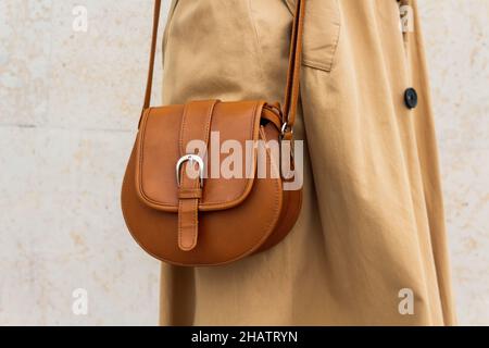 Beige small bag with long strap on woman. Stock Photo