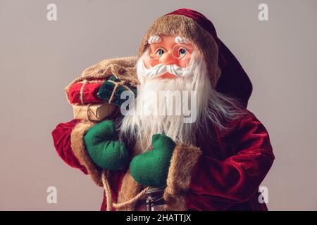 Santa Claus dummy toy with Christmas presents, selective focus Stock Photo