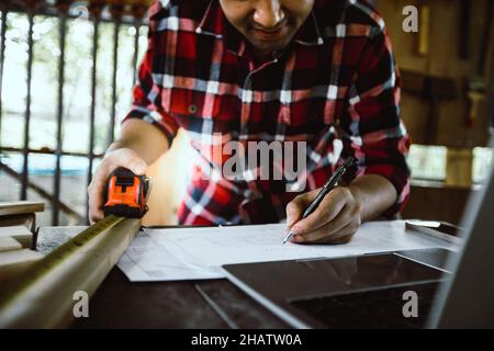 carpenter or architect looking and  sketch on paper working in site work Stock Photo