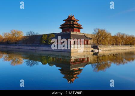 Forbidden City Beijing - Wall and Northwestern watchtower - reflected on surrounding  moat on a clear sky, early winter day. December 1 2021 Stock Photo