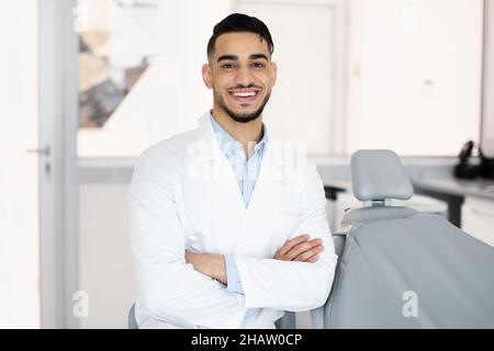 Portrait Of Young Handsome Middle Eastern Dentist Doctor Posing In Clinic Stock Photo