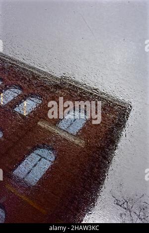 Brick house reflected in puddle, reflection of red house, Amsterdam, Holland Stock Photo