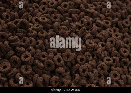 Corn-flakes background and texture. Chocolate rings. Stock Photo