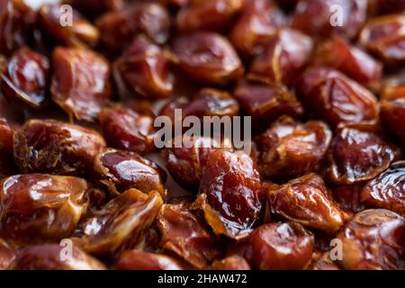 A selective focused close up shot of dates, displayed in a market place in India. Fresh dry dates background concept. Stock Photo