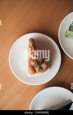 Caramel macadamia cheesecake on the wooden table Stock Photo