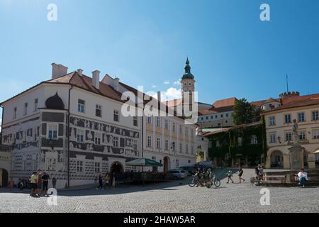 Market square with House to the Knights, sgraffito house in the old town, the castle in the background, Mikulov, Nikolsburg, Breclav district Stock Photo