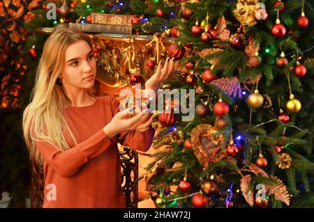 Portrait of teenage girl decorating Christmas tree