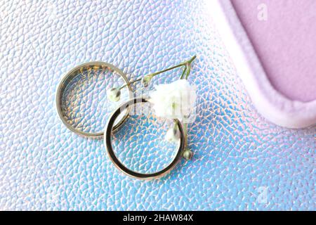 Couple of wedding rings on textured background Stock Photo