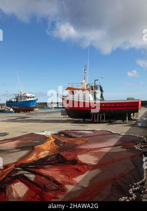 Fishing boats in the dry deck in the harbour, Vila Franca do Campo, Sao Miguel Island, Azores, Portugal Stock Photo