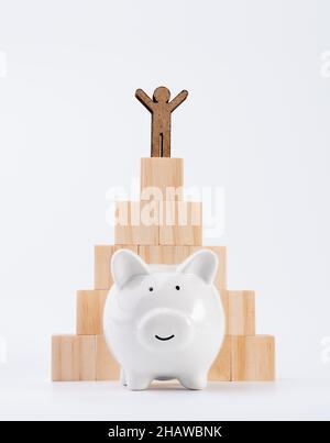 People model stand on wood cubes pyramid and piggy bank isolated on white background ,saving and invesment concept Stock Photo