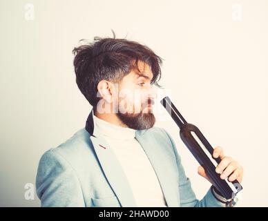 Anonymous alcoholic person drinking from a bottle of alcohol. Stock Photo