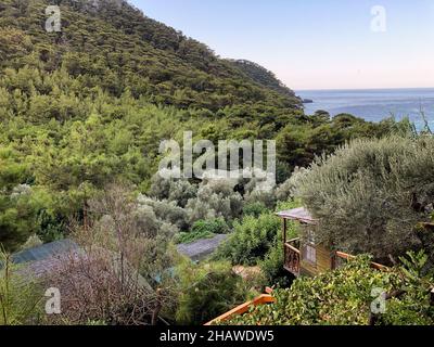 A bungalow house in trees and view of sea in Kabak Bay Mugla. Stock Photo