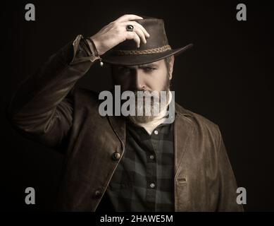 Handsome man in cowboy costume stay in dark. Vampire Hunter. Stock Photo
