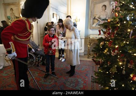 The Duchess of Cornwall alongside Royal equerry Ed Andersen of the Welsh Guards and children who have been invited to decorate the Christmas tree at Clarence House in London. Picture date: Wednesday December 15, 2021. Stock Photo