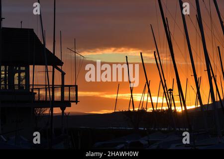 Largs, Scotland, UK The sun sets behind Largs yacht haven in North Ayrshire Stock Photo
