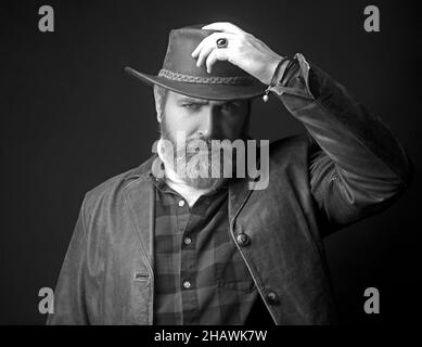 Handsome man in cowboy costume stay in dark. Vampire Hunter. Stock Photo