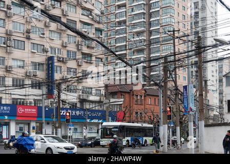 Shanghai, China - February, 2019. Messy tangle of electrical and telephone wires on the street pole. Stock Photo