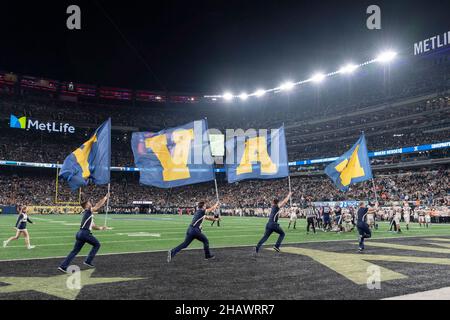 East Rutherford, United States of America. 11 December, 2021. U.S. Naval Academy cheerleaders encourage the team during the annual Army-Navy football game at Metlife Stadium December 11, 2021 in East Rutherford, New Jersey. The U.S. Naval Academy Midshipmen defeated the Army Black Knights 17-13 in their 122nd matchup.  Credit: Stacy Godfrey/DOD/Alamy Live News Stock Photo